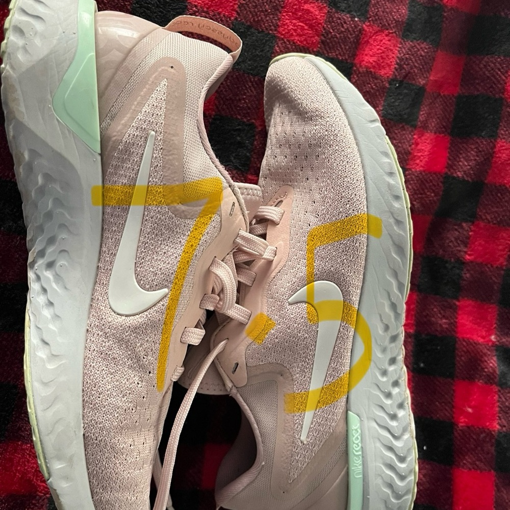 Light pink NIKE tennis shoes.